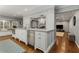 Kitchen island featuring stainless steel appliances, granite countertops, wooden floors and custom white cabinets at 2240 Six Branches Dr, Roswell, GA 30076
