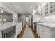 Bright kitchen with stainless steel appliances, white cabinets, hardwood floors, and granite countertops at 2240 Six Branches Dr, Roswell, GA 30076