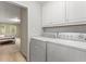 A conveniently located laundry room, near the bedroom, featuring modern appliances and storage at 2240 Six Branches Dr, Roswell, GA 30076