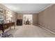 Bright living room with neutral walls, carpet and view into dining room with natural light from the window at 2240 Six Branches Dr, Roswell, GA 30076