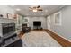 Well-lit living room boasting hardwood floors, a cozy fireplace, and an inviting atmosphere at 2240 Six Branches Dr, Roswell, GA 30076