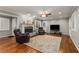 Spacious living room with a fireplace, hardwood floors, and large windows providing ample natural light at 2240 Six Branches Dr, Roswell, GA 30076