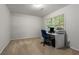 Carpeted office space featuring a desk with computer setup and a comfortable office chair at 2240 Six Branches Dr, Roswell, GA 30076