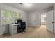 An office space featuring natural light, a functional desk setup, and convenient access to an adjoining bathroom at 2240 Six Branches Dr, Roswell, GA 30076