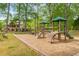 Charming playground with a wooden structure and slides nestled in a wooded area at 2240 Six Branches Dr, Roswell, GA 30076