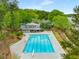 Community pool and recreation area featuring a large swimming pool, tennis courts, and lake access at 2240 Six Branches Dr, Roswell, GA 30076