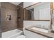 Modern bathroom features a tub, tiled walls, and a stylish vanity at 3131 Sumter Ct, Marietta, GA 30062