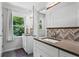 Bright bathroom featuring double sinks and herringbone backsplash at 3131 Sumter Ct, Marietta, GA 30062