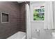 Stylish bathroom showcasing a tiled shower and tub, and a window at 3131 Sumter Ct, Marietta, GA 30062