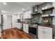 Well-lit kitchen features stainless steel appliances, white cabinets, and beautiful wood flooring at 3131 Sumter Ct, Marietta, GA 30062