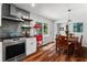 Modern kitchen flows into dining area, complete with stainless steel appliances and wood floors at 3131 Sumter Ct, Marietta, GA 30062
