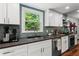 Bright kitchen with white cabinets, stainless steel appliances, and a view of the backyard at 3131 Sumter Ct, Marietta, GA 30062