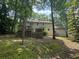 Rear view of home highlighting multiple decks, with access from the upper and lower levels, surrounded by trees at 4782 Donnegal Se Ct, Mableton, GA 30126