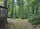 Lush backyard featuring mature trees and landscaping, creating a private and serene outdoor space at 4782 Donnegal Se Ct, Mableton, GA 30126