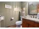 Stylish half bathroom featuring wood cabinet, granite countertops, and decorative striped wallpaper at 4782 Donnegal Se Ct, Mableton, GA 30126