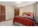 Comfortable bedroom features a bed, soft carpet, and a door to another room at 4782 Donnegal Se Ct, Mableton, GA 30126