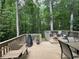 Spacious wooden deck featuring outdoor furniture, offering a comfortable area for entertaining or relaxing surrounded by trees at 4782 Donnegal Se Ct, Mableton, GA 30126