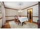 Formal dining room with floral wallpaper, hardwood floors, and a chandelier at 4782 Donnegal Se Ct, Mableton, GA 30126