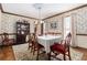 Elegant dining room with a large table, hardwood floors, and a china cabinet at 4782 Donnegal Se Ct, Mableton, GA 30126