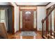 Elegant foyer with a decorative wood door, hardwood floors, and a staircase at 4782 Donnegal Se Ct, Mableton, GA 30126
