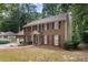Inviting brick two-story home with a covered entrance and mature landscaping in a wooded setting at 4782 Donnegal Se Ct, Mableton, GA 30126