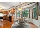 Eat-in kitchen with wood cabinets, hardwood floors, and a breakfast nook overlooking the backyard at 4782 Donnegal Se Ct, Mableton, GA 30126