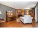 Inviting living room with hardwood floors, a brick fireplace, and neutral-toned furniture, including a piano at 4782 Donnegal Se Ct, Mableton, GA 30126