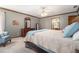 Cozy bedroom showcasing neutral walls, ceiling fan, and furniture with adjoining bathroom at 4782 Donnegal Se Ct, Mableton, GA 30126