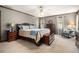 Spacious bedroom featuring a king-size bed, ceiling fan, side tables, dressers, and natural light at 4782 Donnegal Se Ct, Mableton, GA 30126