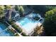 Aerial view of the community pool, pool house and tennis courts in a wooded setting at 558 Olympic Way, Acworth, GA 30102