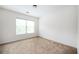 A simple carpeted bedroom featuring a window for natural light at 558 Olympic Way, Acworth, GA 30102