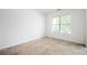 Cozy bedroom with neutral carpet, a window, and ample natural light at 558 Olympic Way, Acworth, GA 30102