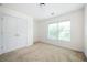 Neutral bedroom featuring a window and a closet with double doors at 558 Olympic Way, Acworth, GA 30102