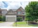 Beautiful two-story home featuring a two-car garage, stone accents, and well-maintained landscaping at 558 Olympic Way, Acworth, GA 30102