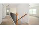 Hallway with carpet flooring, railing, and white walls at 558 Olympic Way, Acworth, GA 30102