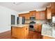 Kitchen featuring stainless appliances, granite countertops, wood cabinets, and central island at 558 Olympic Way, Acworth, GA 30102