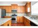 Kitchen with stainless steel appliances, gas range, wood cabinets, and granite countertops at 558 Olympic Way, Acworth, GA 30102