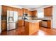 Stylish kitchen featuring stainless appliances, granite countertops, wood cabinetry, and a center island at 558 Olympic Way, Acworth, GA 30102