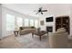 Bright living room with fireplace, ceiling fan, and large windows offers a comfortable gathering space at 558 Olympic Way, Acworth, GA 30102