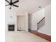 Inviting living room features a cozy fireplace and staircase to upper levels of the home at 558 Olympic Way, Acworth, GA 30102