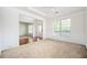 Elegant living space showcasing neutral carpet, decorative trim, and ample natural light at 558 Olympic Way, Acworth, GA 30102