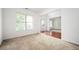 Bright room featuring neutral carpet and light-filled view into adjacent living spaces at 558 Olympic Way, Acworth, GA 30102