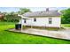View of the backyard featuring a gravel area under a carport and a well-maintained lawn at 8573 Campbellton St, Douglasville, GA 30134