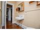 Bathroom featuring a vintage sink, toilet, and medicine cabinet at 8573 Campbellton St, Douglasville, GA 30134