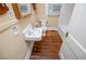 Bathroom featuring a vintage sink, toilet, and a tiled bathtub at 8573 Campbellton St, Douglasville, GA 30134