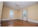 Sunlit bedroom with wood floors, neutral walls, and a ceiling fan for added comfort at 8573 Campbellton St, Douglasville, GA 30134