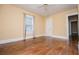 Comfortable bedroom with hardwood floors, neutral walls, and a window at 8573 Campbellton St, Douglasville, GA 30134