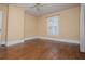 Cozy bedroom with wood floors, light walls, and natural light from the window at 8573 Campbellton St, Douglasville, GA 30134