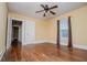 Bedroom featuring hardwood floors, neutral walls, window, and ceiling fan at 8573 Campbellton St, Douglasville, GA 30134