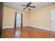 Bedroom featuring hardwood floors, neutral walls, window, and ceiling fan at 8573 Campbellton St, Douglasville, GA 30134